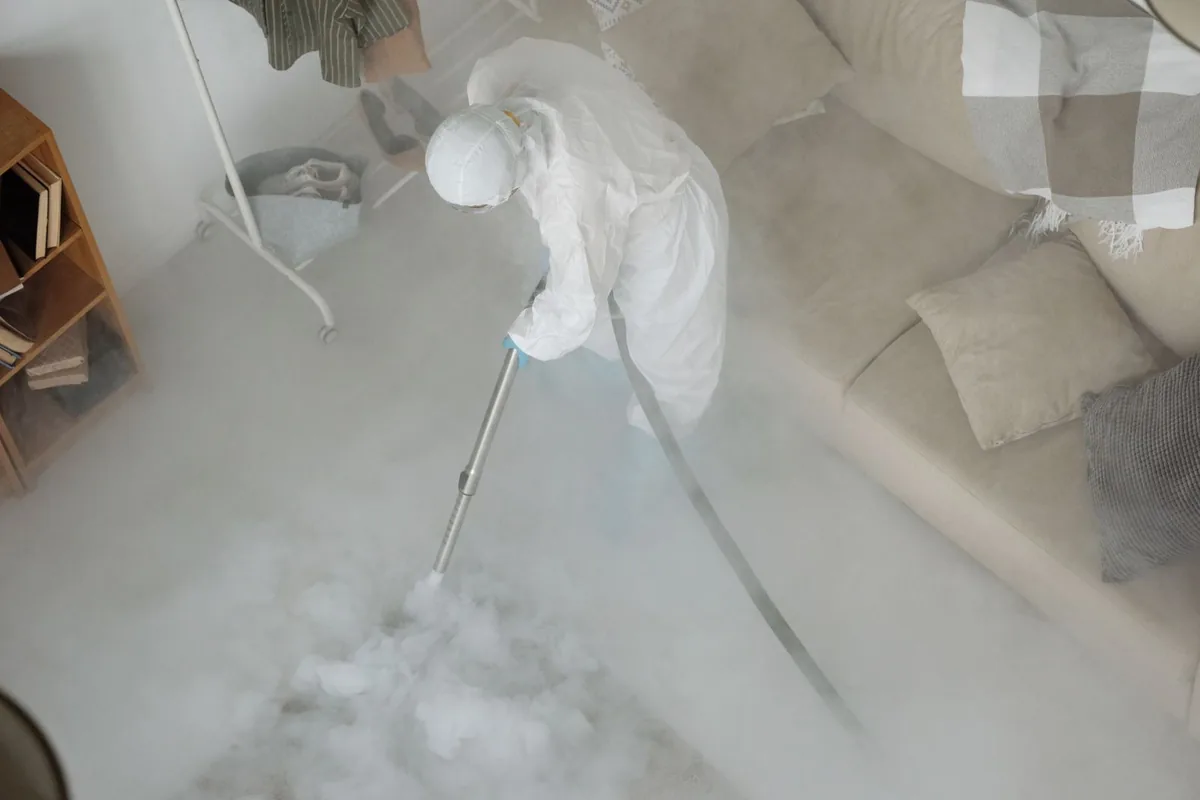 Biohazard cleanup technician in protective equipment, Berryville, TX